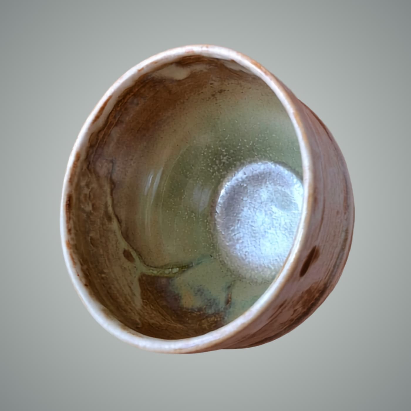Handmade stoneware bowl with four mixed glazes and iron oxide. Celadon green and warm earth interior. Wheel-thrown, one of a kind by ceramist Przemyslaw Golebiewski, Berlin.