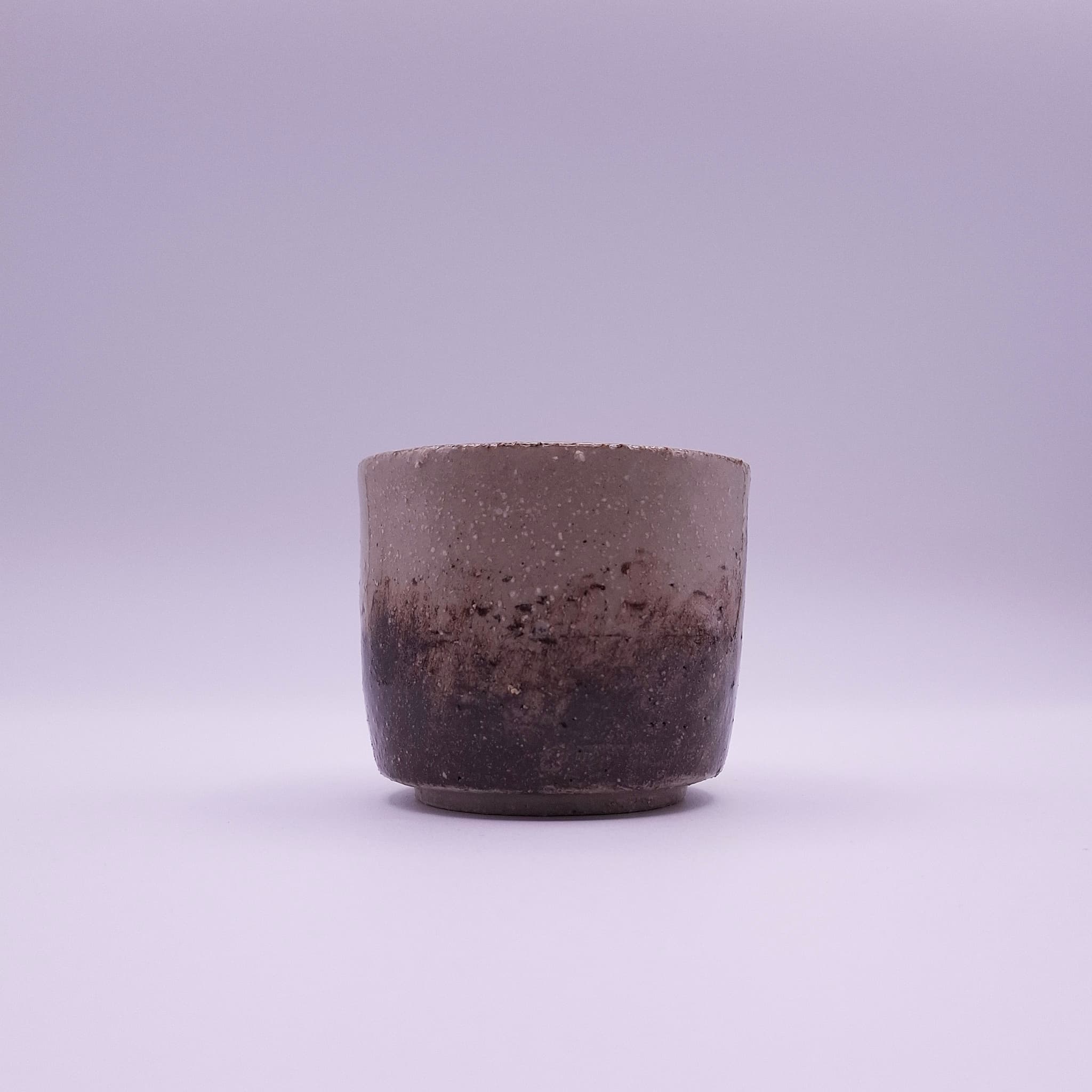 A handbuilt yunomi cup finished with iron oxide and terra rosa, a natural pigment found on a journey. One of a kind, made in Berlin.